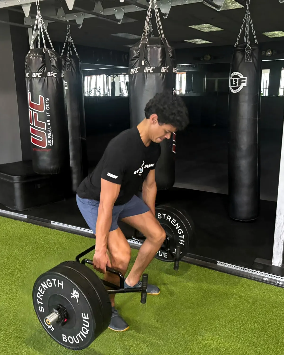 A young athlete lifting with a hex bar