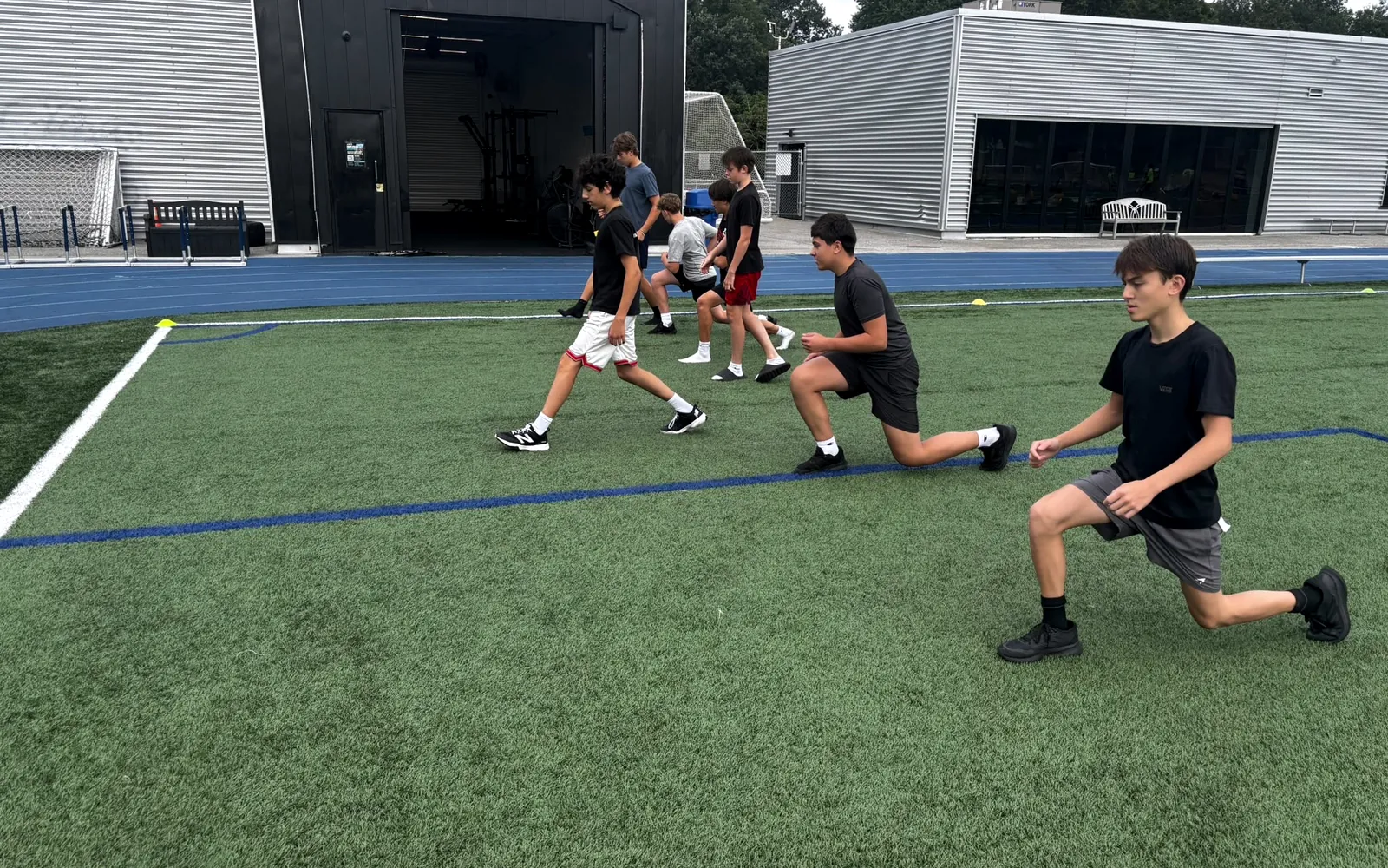 Athletes training outdoors on turf